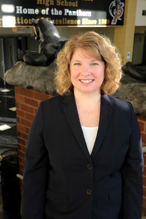 Tracey Harrill smiling in front of panther statue